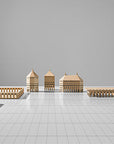 A set of ML Utopia Collection Square Box wooden buildings on a white floor, handmade with love by Madlab.