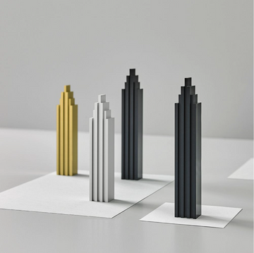 A set of Madlab ML Skyline Collection Black & Silver (2pc set) lego towers resembling New York City's skyline on a white table.