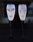 Maleras Crystal Champagne Glass Electra Clear with Kubik Champagne Glass from Masque collection on a black back ground for modern interiors available at Spacio India from the Drink ware of Bar Accessories Collection.