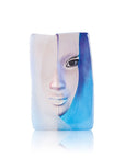A vibrant blue and white vase with a woman's face on it, crafted in the style of Maleras Crystal Sculpture's Mazzai Blue.