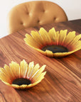 Maleras Crystal Sunflower Bowl Small Bowl with other Sunflower Big Bowl on wood dining table in dining interior room for modern homes available at Spacio India from Decor Accessories and Tableware Collection of Decorative Bowls.