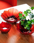Maleras Small Crystal Poppy Bowl – Red & Black Glass Art by Maleras, elegantly styled with a candle and green plant, available at Spacio India retail stores and online.