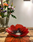 Maleras Red & Black Small Crystal Poppy Bowl artfully placed on a rustic wooden table, detailed sandblasted design by Maleras at Spacio India.