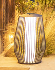 Decorative outdoor solar lamp with a wicker-like design on a patio by Les Jardins available at Spacio retail stores in Mumbai & Kolkata.