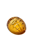 Decorative amber crystal decor with a grid pattern on a white background