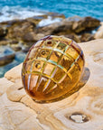 Decorative crystal centre pieces on a rock with ocean in the background