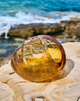 Crystal decor centre piece on a rock with ocean waves in the background