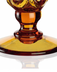 A stunning Mario Cioni Crystal Arabesque Vase Amber made of orange and yellow glass stands elegantly against a clean white background. This crystal ware piece beautifully showcases the exquisite craftsmanship of Mario Cioni.