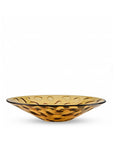 Amber crystal bowl with wavy design on a white background from Mario Cioni available at Spacio in India