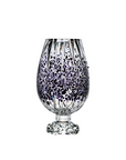 Decorative crystal vase with black speckled pattern on a white background