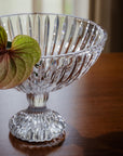 Clear crystal bowl with decorative patterns on a wooden surface