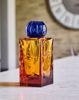The IO Love Amber Blue Vase by Mario Cioni on a white background on a marble surface