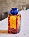 The IO Love Amber Blue Vase by Mario Cioni on a white background on a marble surface