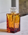 The IO Love Amber clear Vase by Mario Cioni on a marble background