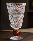 Decorative crystal glass with a textured design on a wooden surface