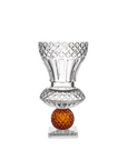 Crystal glass with an amber base on a white background