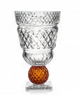 Crystal vase with amber sphere on a white background from Mario Cioni at Spacio store in India.