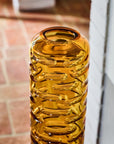 Crystal vase with textured design on a tiled floor