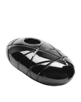 Black, oval-shaped sculptural crystal object with a textured surface on a white background