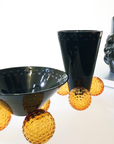 Mario Cioni Crystal Acrobat Black Vase with Amber Spheres by Tondo Doni with Acrobat Bowl on a surface available at Spacio India for luxury home decor accessories collection of decorative Vases.