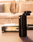 Mario Cioni A.Y.L.I. Cilindric Clear Crystal Vase by Tondo Doni on a coffee table available at spacio india for luxury home decor collection of decorative vases.