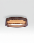 A glass ring with a warm coppery-brown finish, shown from a top-down perspective on a light gray gradient background.