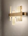 Modern wall lamp with gold and marble finish on a gray wall by Masiero available at Spacio retail stores in Mumbai & Kolkata.