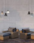 Outdoor furniture set with cushions against a tiled wall along with outdoor pendant lights from Masiero, available at Spacio.