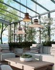 Modern outdoor patio with furniture, plants, and hanging lights.