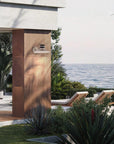 Ocean view and lounge chairs with Masiero's Cordea outdoor light on the wall in white colour