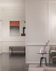 Modern living room with a gray sofa, coffee table, and wall art with Masiero Cristalle wall lights