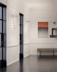 Modern interior with a bench, abstract painting, and decorative wall lights.