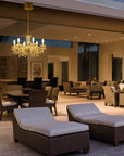 Luxury lounge area with chandelier, couches, and chairs in a high-end interior setting.