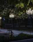 Decorative outdoor chandeliers on a building exterior at night