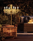 Decorative Table chandelier in an outdoor setting with a couch and lanterns.
