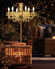 Decorative Table chandelier in an outdoor setting with a couch and lanterns.