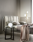A simple bedroom with a Masiero Posy Flor lamp, bed and side table, embodying both simplicity and balance. Styled by Spacio Interior Styling team