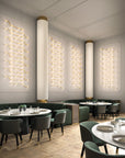 Modern restaurant interior with round tables, chairs, and decorative modular light fittings from Masiero