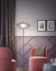 A luxury living room with the Eye shaped floor lamp from Masiero Visio Collection with pink interiors styled by Spacio Interior Styling team