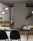 A surreal dining room with a cluster of Eye shaped pendant lights from Masiero Visio Collection table and chairs, where imagination transforms the usual facial geometries into abstract forms. Styled by Spacio Interior Styling team