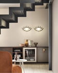 A luxury living and dining room decorated with luxury home decor products and Masiero Eye shaped Wall sconce on a dining side board, styled by Spacio Interior Styling team