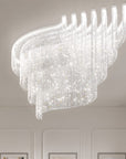 Modern chandelier hanging from a ceiling in a well-lit room.