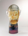 Murano Glass sculpture of a face with a gradient color effect on a white background