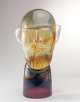Murano Glass sculpture of a face with a gradient color effect on a white background