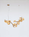 Gold chandelier with floral design on a white background