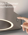 Hand touching a touchdimmer switch on a rechargeable light fixture with 'Touchdimmer' text.
