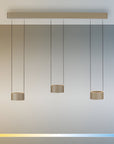 Modern pendant light fixture with three hanging lights against a gradient background