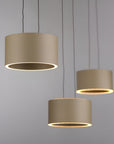 Three beige pendant lights hanging against a gray background