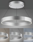 Modern kinetic chandelier with circular design on a gray background