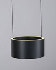 Black cylindrical pendant light with a gray background